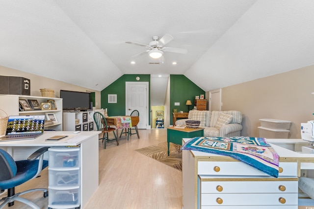 game room featuring ceiling fan, lofted ceiling, light hardwood / wood-style floors, and a textured ceiling