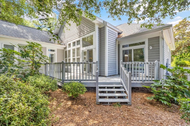 rear view of property featuring a deck