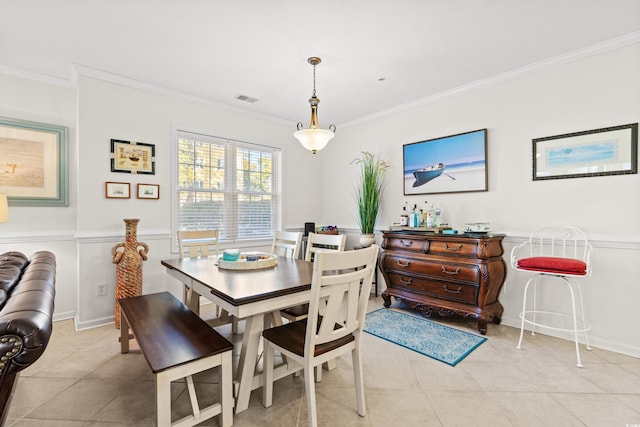 dining room with ornamental molding and light tile patterned floors