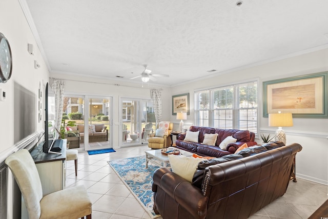 living room with light tile patterned floors, ceiling fan, ornamental molding, a textured ceiling, and french doors