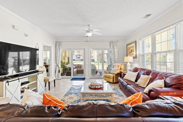 living room featuring ornamental molding, light tile patterned floors, a textured ceiling, and ceiling fan