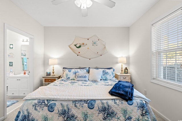 bedroom featuring light tile patterned floors, ensuite bath, and ceiling fan