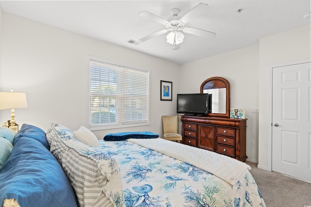 bedroom featuring ceiling fan and carpet