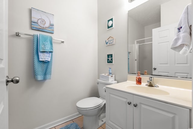 bathroom featuring tile patterned floors, toilet, a shower with shower door, and vanity