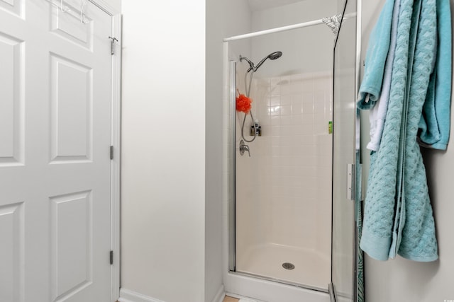 bathroom featuring a shower with shower door