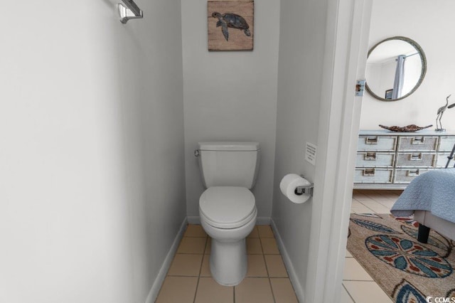 bathroom featuring baseboards, toilet, and tile patterned floors