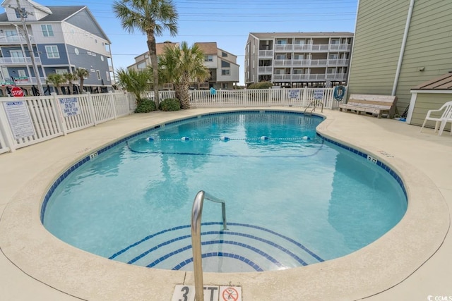 pool with fence and a patio