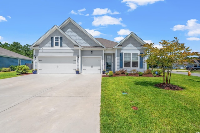 craftsman house featuring a front lawn, a garage, and driveway