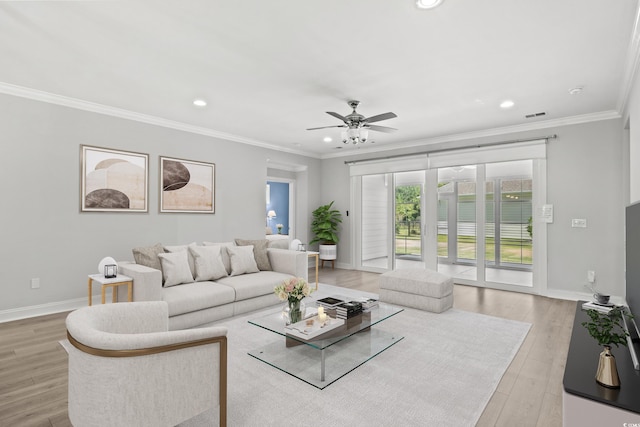 living room with ceiling fan, ornamental molding, and light hardwood / wood-style floors