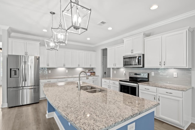 kitchen featuring white cabinetry, appliances with stainless steel finishes, sink, and an island with sink