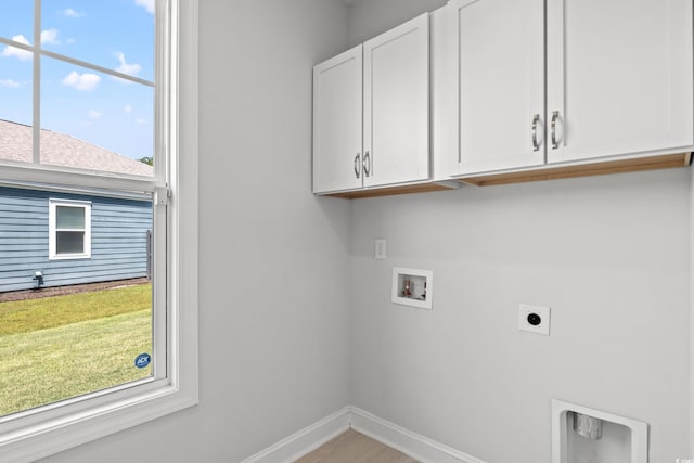 clothes washing area featuring washer hookup, cabinets, and hookup for an electric dryer