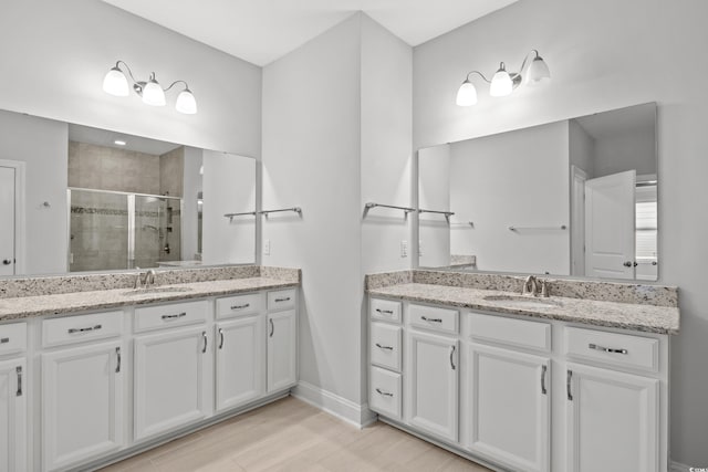 bathroom featuring vanity, hardwood / wood-style flooring, and walk in shower