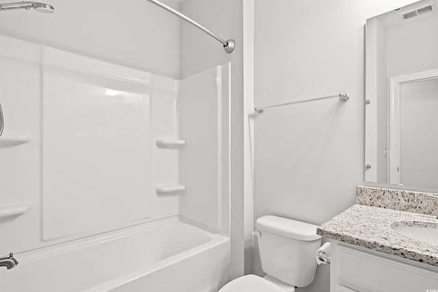 full bathroom featuring washtub / shower combination, vanity, and toilet