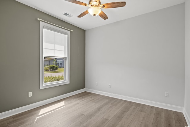 empty room featuring ceiling fan and light hardwood / wood-style floors