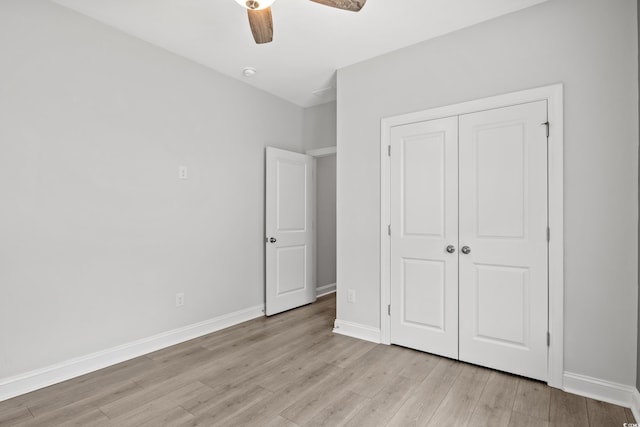 unfurnished bedroom featuring light hardwood / wood-style floors, a closet, and ceiling fan