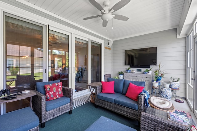 sunroom / solarium featuring ceiling fan