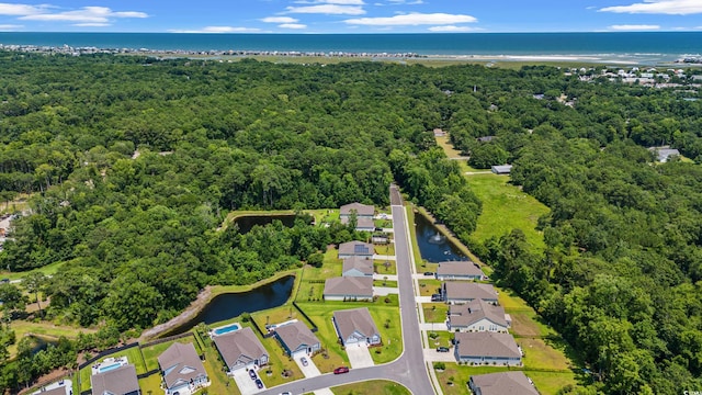 bird's eye view with a residential view, a wooded view, and a water view