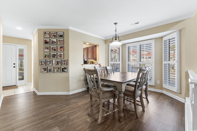 dining room featuring crown molding and dark hardwood / wood-style flooring