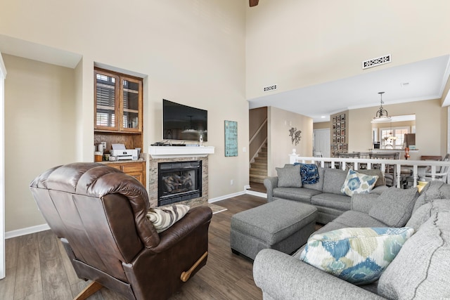 living room featuring a high ceiling and dark hardwood / wood-style floors