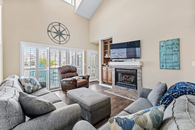 living room with dark hardwood / wood-style floors and high vaulted ceiling