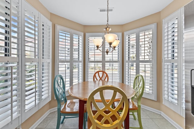 tiled dining area featuring a chandelier