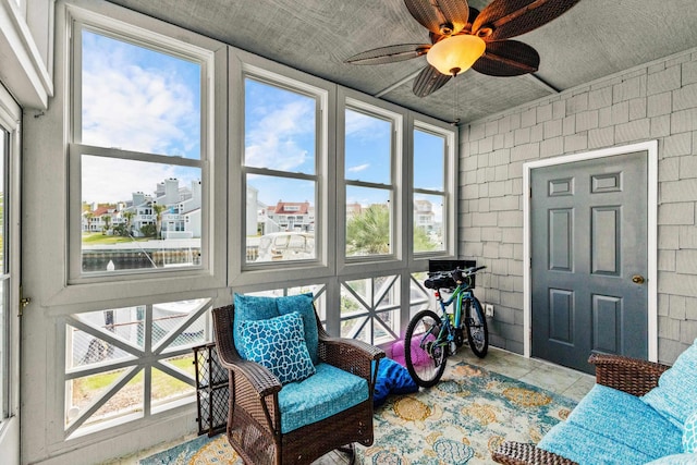 sunroom featuring ceiling fan