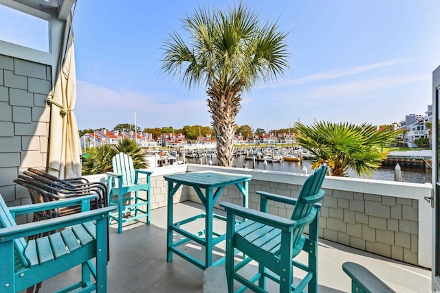 balcony with a water view and a patio area