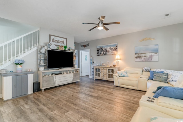 living room with hardwood / wood-style flooring and ceiling fan