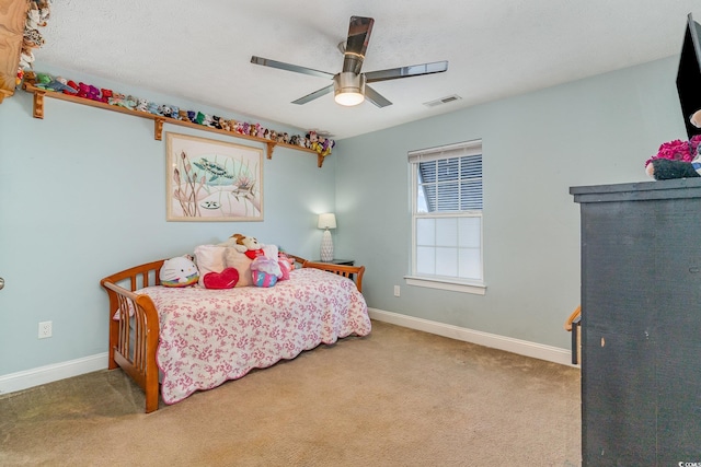 bedroom featuring ceiling fan and carpet