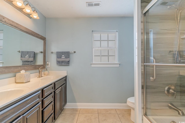 bathroom featuring walk in shower, tile patterned floors, toilet, and vanity