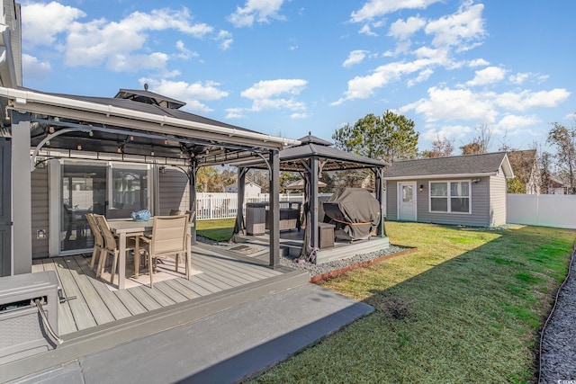 deck with an outbuilding, a yard, and a gazebo