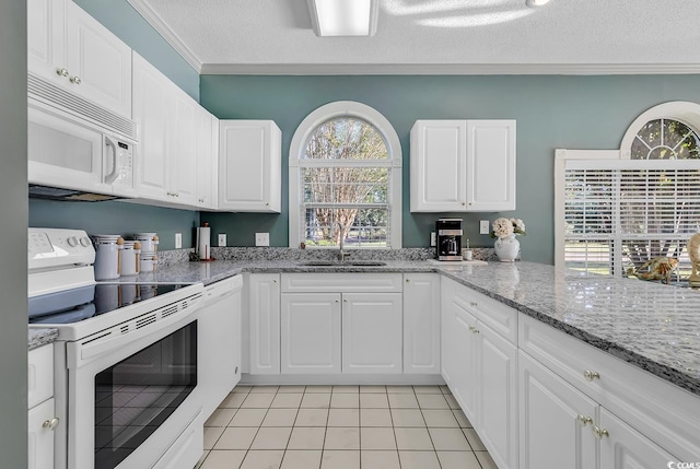 kitchen with white cabinetry, white appliances, crown molding, and sink