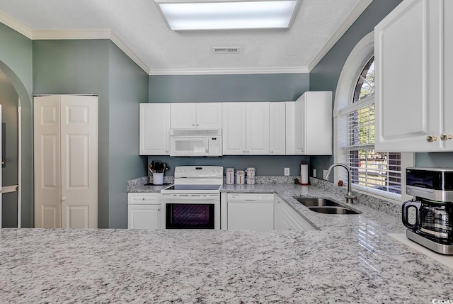 kitchen with crown molding, sink, white appliances, and white cabinets