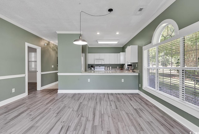 kitchen with white cabinetry, crown molding, kitchen peninsula, and hanging light fixtures