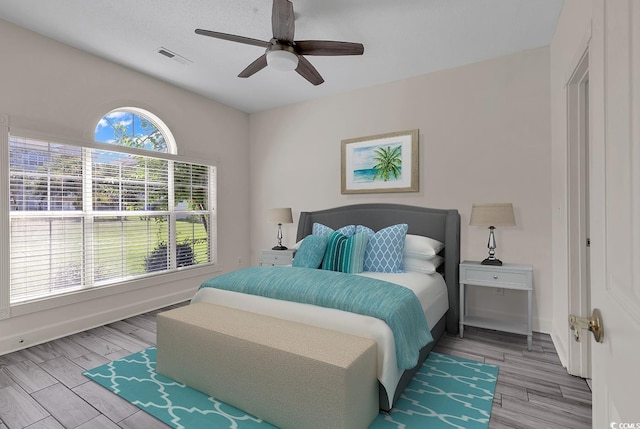 bedroom featuring light hardwood / wood-style floors and ceiling fan