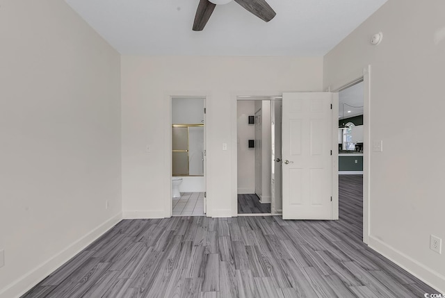 unfurnished bedroom with ensuite bath, light hardwood / wood-style flooring, and ceiling fan