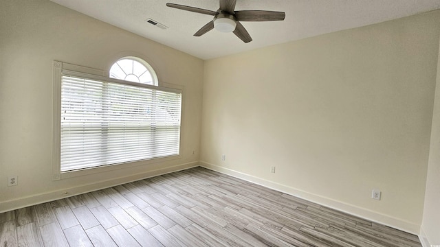 spare room featuring ceiling fan and light hardwood / wood-style floors