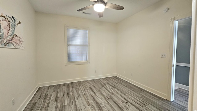 spare room featuring hardwood / wood-style floors and ceiling fan