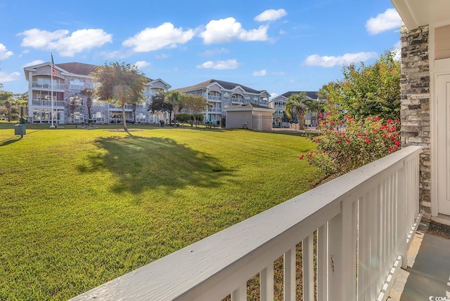 view of yard with a balcony