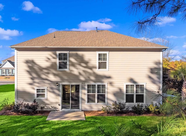 back of property with a patio area and a lawn