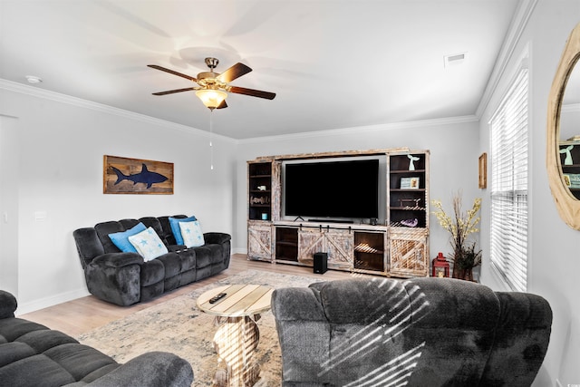 living room with light hardwood / wood-style flooring, ornamental molding, and ceiling fan