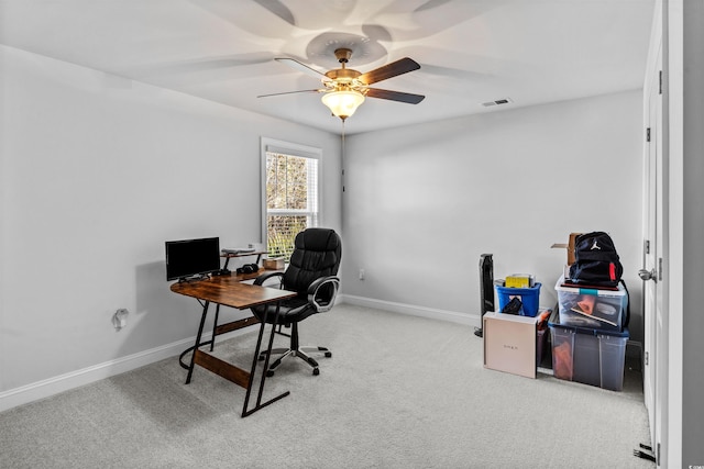 carpeted office featuring ceiling fan