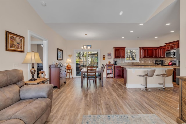 living room featuring a notable chandelier and light hardwood / wood-style flooring