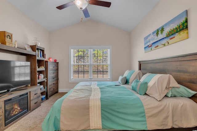 carpeted bedroom featuring lofted ceiling and ceiling fan