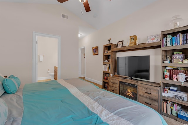 bedroom featuring vaulted ceiling, connected bathroom, and ceiling fan