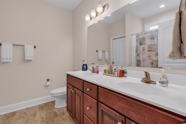 bathroom featuring walk in shower, vanity, and toilet