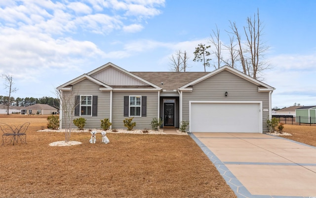 ranch-style home with a garage and a front lawn