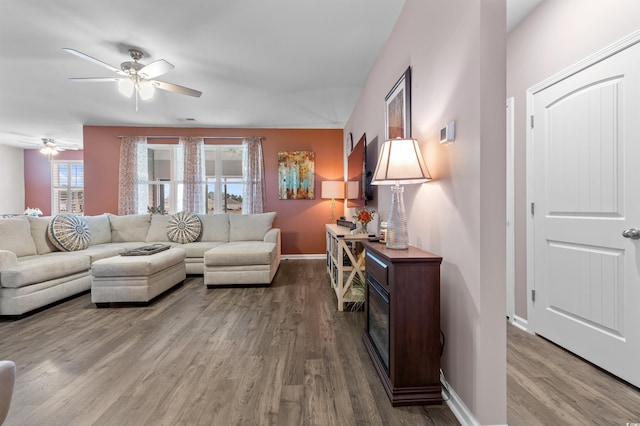 living room featuring hardwood / wood-style flooring and ceiling fan