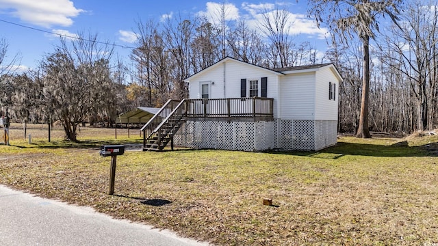 view of front facade featuring a deck, a carport, and a front lawn