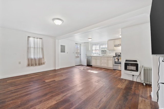 unfurnished living room with radiator, heating unit, and dark hardwood / wood-style floors